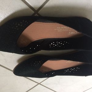 Tom's black suede shoes